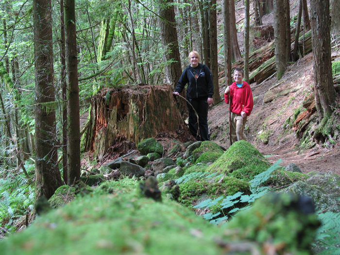 Isabella and Karl pose by a fallen tree