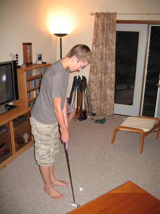 Erik tries out one of many golf clubs that Mike has built himself