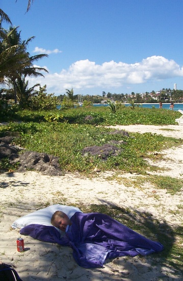 Karl sleeping under a cover in the shade