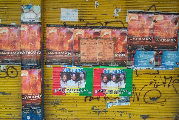 Posters for music bands on a wall in Point-a-Pitre